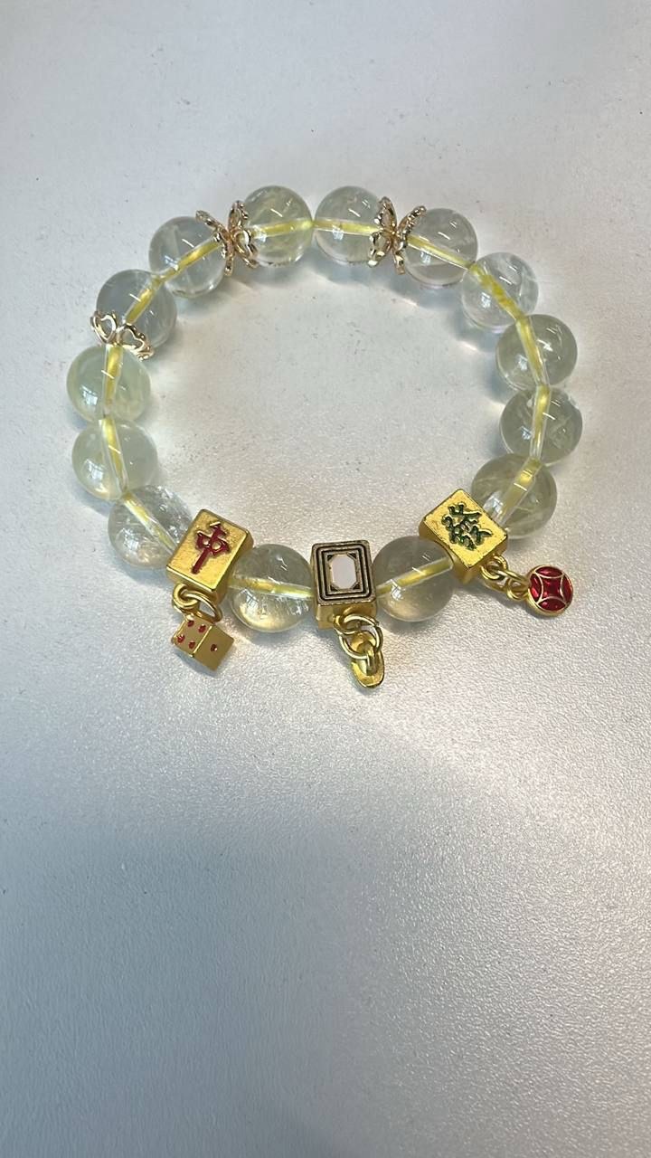 Hand-strung charm bracelet detail